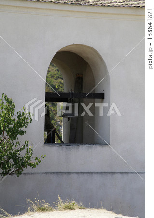 A fragment of an arched bell tower window. A fragment of an arched bell tower window. 138641821