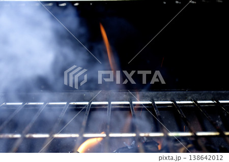 Outside BBQ Grill With Bright Flames And Glowing Coals ready for cooking on Outside BBQ Grill With Bright Flames And Glowing Coals ready for cooking on 138642012