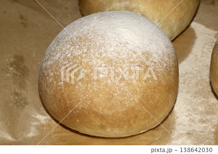 Home made bread roll baps freshly cooked with flour sprinkled on top 138642030