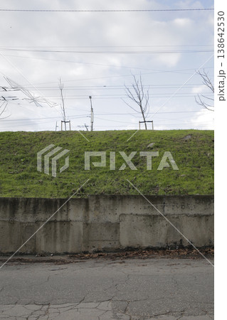 A roadside slope covered with green grass. A roadside slope covered with green grass. 138642530
