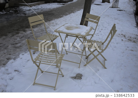 Snow covered closed outdoor cafe. 138642533