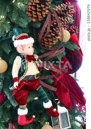 The Christmas tree is decorated with a cute elf. 138642974