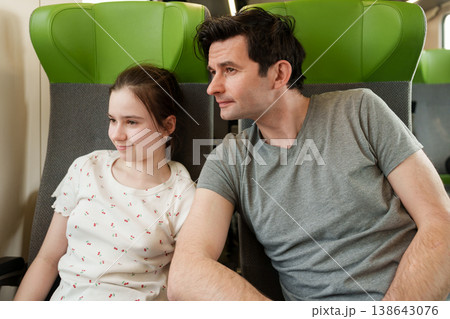 Father and daughter traveling together by train Father and daughter traveling together by train 138643076