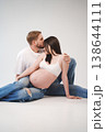 Couple lovingly embraces during maternity photo session 138644111
