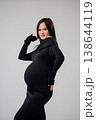 Expecting mother poses confidently in stylish outfit 138644119