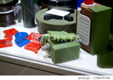 Booby trap models printed on 3D printer. Prototype of ammunition explosive devices printed on 3D printer from molten plastic. Innovation modern additive technologies. 3D printing military technology Booby trap models printed on 3D printer. Prototype of ammunition explosive devices printed on 3D printer from molten plastic. Innovation modern additive technologies. 3D printing military technology 138644588
