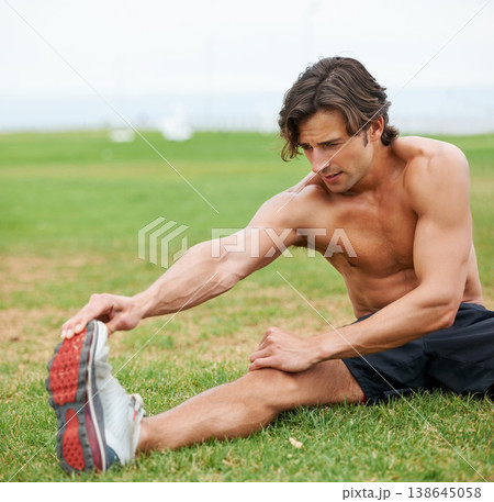 Fitness, stretching and man on field for workout, summer sports and wellness in outdoor training. Exercise, warm up for legs and shirtless athlete on grass for health, muscle and body care commitment 138645058