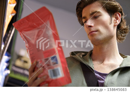 Man, product or label information in grocery store or nutrition value, choice or customer decision. Male person, thinking or read protein or calories search in package, purchase direction or benefits Man, product or label information in grocery store or nutrition value, choice or customer decision. Male person, thinking or read protein or calories search in package, purchase direction or benefits 138645083