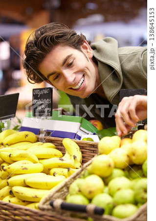 Man, fruit and supermarket choice for health diet, nutrition or shopping product sale. Male person, happy customer or pear stock in grocery store for organic vegan offer, quality price or fibre food 138645153