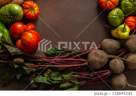 A group of fresh vegetables is placed in a circle on a wooden table. There are carrots, tomatoes, and beets. The colors are bright, indicating freshness and quality A group of fresh vegetables is placed in a circle on a wooden table. There are carrots, tomatoes, and beets. The colors are bright, indicating freshness and quality 138645285