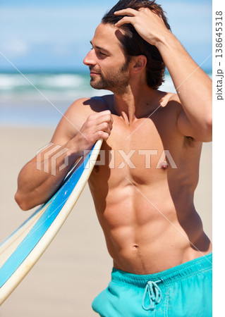 Surfing, fitness and man at a beach with surfboard for training, hobby or fun in nature. Water, sports and male surfer relax at sea for travel, freedom and adventure, workout or exercise in Hawaii Surfing, fitness and man at a beach with surfboard for training, hobby or fun in nature. Water, sports and male surfer relax at sea for travel, freedom and adventure, workout or exercise in Hawaii 138645318