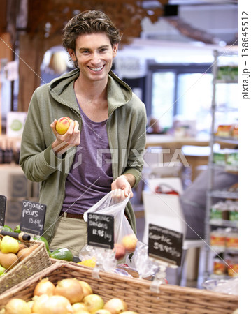 Man, portrait and fruit shopping in grocery store for fibre nutrition, vegan food and healthy choice. Male person, smile and peach bag supermarket for organic health diet, vitamins or happy customer Man, portrait and fruit shopping in grocery store for fibre nutrition, vegan food and healthy choice. Male person, smile and peach bag supermarket for organic health diet, vitamins or happy customer 138645512