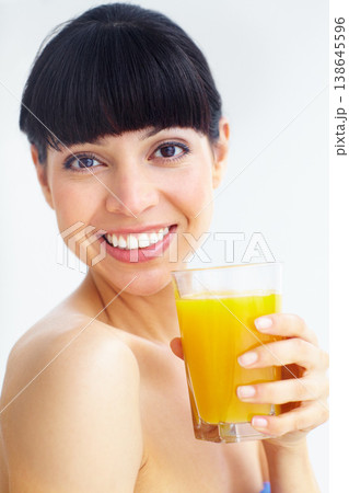 Orange juice, studio portrait and happy woman with glass drink for hydration, liquid fruit detox or natural weight loss. Vitamin C, organic beverage and face of person thirsty on white background Orange juice, studio portrait and happy woman with glass drink for hydration, liquid fruit detox or natural weight loss. Vitamin C, organic beverage and face of person thirsty on white background 138645596