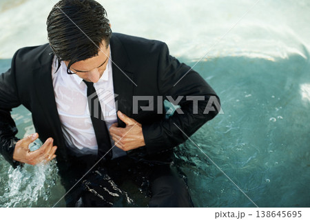 Water, pool and a business man in debt during depression of the economy or financial crisis. Finance, challenge and unemployment with a young corporate employee wet in a suit during recession Water, pool and a business man in debt during depression of the economy or financial crisis. Finance, challenge and unemployment with a young corporate employee wet in a suit during recession 138645695