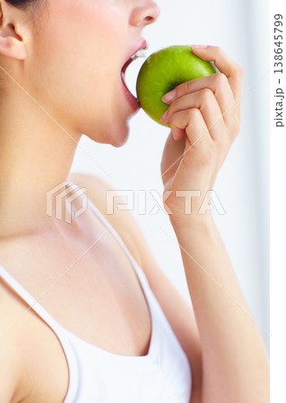 Closeup, eating and woman with health, apple or wellness with detox on a white studio background. Person, girl or model with fruit, nutrition or hungry with diet plan, food or natural with digestion Closeup, eating and woman with health, apple or wellness with detox on a white studio background. Person, girl or model with fruit, nutrition or hungry with diet plan, food or natural with digestion 138645799