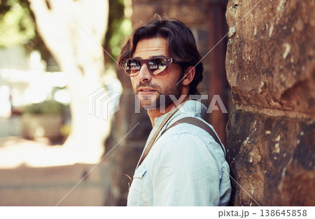 Tourist, sunglasses or man in Italy on holiday, vacation or weekend trip for a adventure in park. Relax, travel or male person with fashion, cool style or freedom sightseeing in urban town on journey 138645858