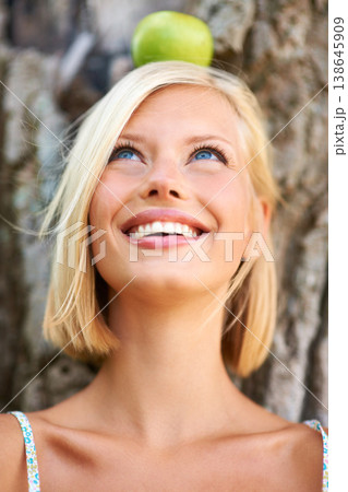 Woman, face and thinking with smile for apple by tree in natural nutrition, diet or health and wellness in nature. Female person with organic green fruit in wonder for healthy vitamin, snack or meal Woman, face and thinking with smile for apple by tree in natural nutrition, diet or health and wellness in nature. Female person with organic green fruit in wonder for healthy vitamin, snack or meal 138645909