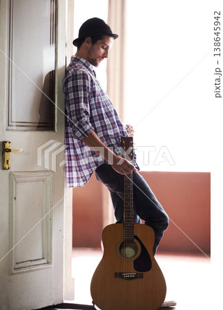 Musician, waiting and man with a guitar, instrument and singer in a music studio. Creative, artist and guitarist standing in home and thinking of performance, equipment or listening to audio of band Musician, waiting and man with a guitar, instrument and singer in a music studio. Creative, artist and guitarist standing in home and thinking of performance, equipment or listening to audio of band 138645942