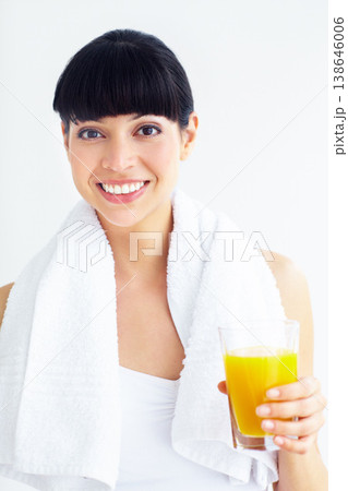 Orange juice, fitness studio portrait and happy woman with glass drink for training, cardio or exercise hydration. Relax, happiness and girl thirsty for liquid, citrus or beverage on white background 138646006
