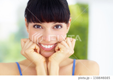 Happy, smile and portrait of young woman in home with good, confident and positive attitude. Excited, happiness and female model with optimistic or satisfaction face in living room in modern house. 138646085