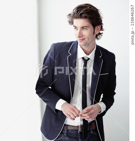 Happy, fashion and young man by a wall with formal, stylish and classy outfit for confidence. Smile, suit and male model from Canada with elegant, cool and trendy style by white background space. 138646267