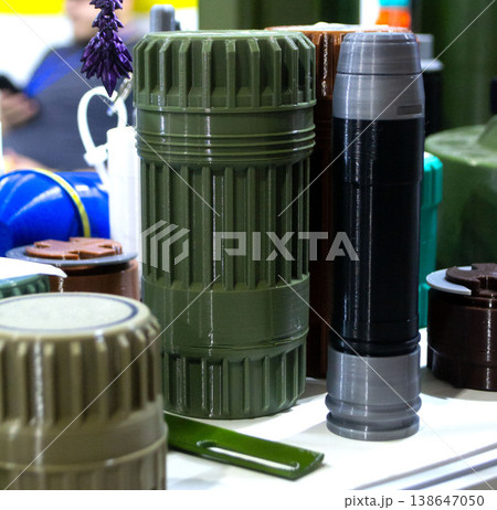 Sealed match container, grenade launcher shot and other elements printed on 3D printer. Prototype of ammunition printed on 3D printer. Innovation modern additive technologies. 3D printing technology Sealed match container, grenade launcher shot and other elements printed on 3D printer. Prototype of ammunition printed on 3D printer. Innovation modern additive technologies. 3D printing technology 138647050