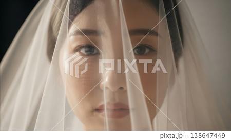 Wedding - Asian Bride Portrait Behind Sheer White Veil Mesh Fabric Gazing Forward Elegant Bridal Beauty 138647449