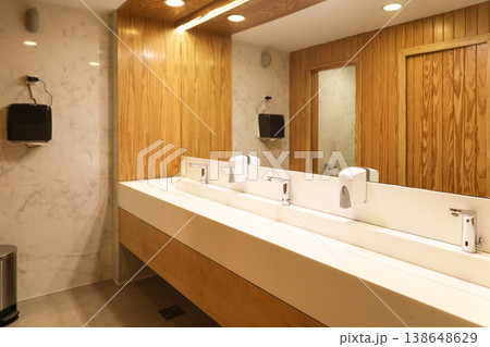 A bathroom with a large mirror covering the entire wall A bathroom with a large mirror covering the entire wall 138648629