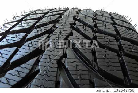 Contact patch of studless tire with symmetrical tread pattern macro shot Contact patch of studless tire with symmetrical tread pattern macro shot 138648759