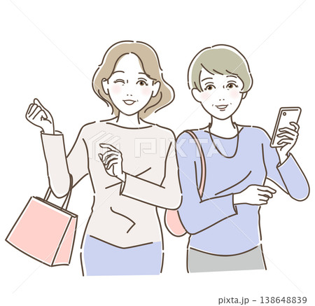 買い物をしながらスマートフォンを見る若々しいミドル・シニア女性二人組 買い物をしながらスマートフォンを見る若々しいミドル・シニア女性二人組 138648839