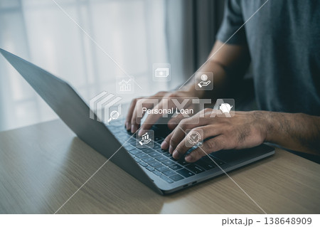 Hands typing on laptop with icons representing personal loan services, fintech solutions, online banking, and financial management showcased in modern workspace 138648909