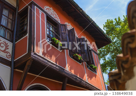 Balabanov House in Plovdiv with wooden shutters, orange facade, decorative ornaments and flower windows, traditional Bulgarian architecture, travel destination culture tourism Balabanov House in Plovdiv with wooden shutters, orange facade, decorative ornaments and flower windows, traditional Bulgarian architecture, travel destination culture tourism 138649038