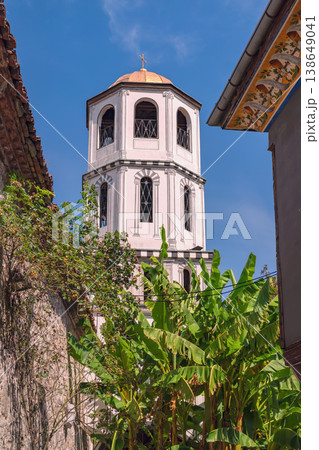 St. Constantine and St. Helena Orthodox Church. Plovdiv church tower with cross rising above old houses and greenery in historic district, architectural detail and urban landscape in Plovdiv Bulgaria 138649041