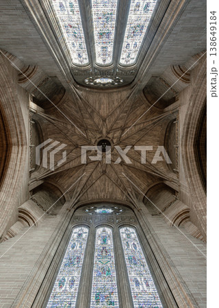 Within the cavernous heart of Liverpool Cathedral, the Under Tower vaulting blooms like a stone flower. Delicate ribs radiate from a central boss, weaving a geometric web against the high shadows. 138649184
