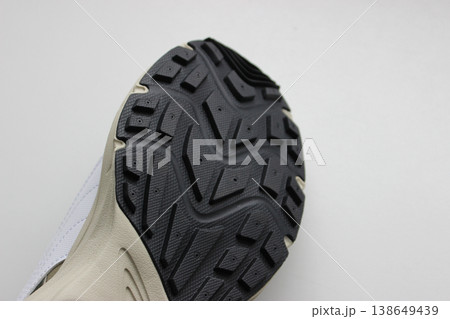 Men's sneaker sole with non-slip rubber insert. Sport shoes for man isolated on white 138649439