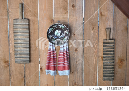 Traditional rustic wall decor with vintage tools and pottery 138651264