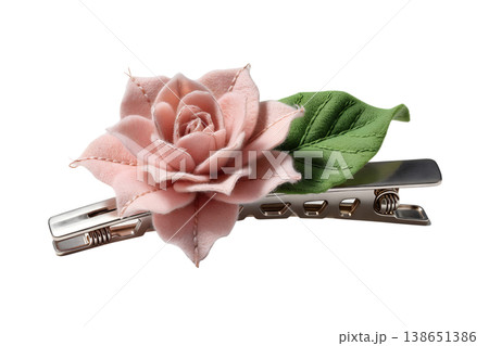Delicate pink rose flower hair clip accessory, isolated or on a clean background, representing beauty, bridal styling, and feminine fashion accessories 138651386