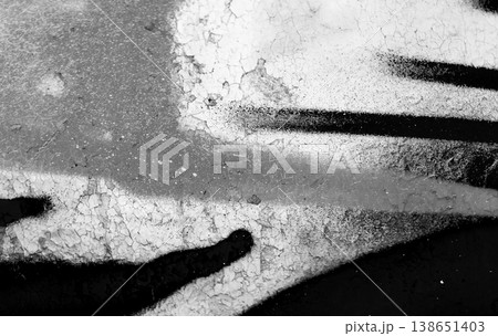Black and white graffiti elements on a weathered wall with bold lines, abstract photo 138651403