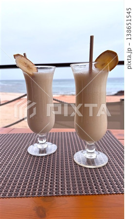 Beachside Drinks With Pineapple And Lemon. Refreshing Tropical Beverages With Fruit Garnishes And Ocean View. Cooling Coconut Pineapple Cocktails With Citrus Accents By Seaside 138651545