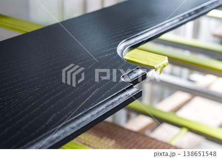 Furniture element made of oak veneer covered with black enamel in a drying chamber during wood treatment process Furniture element made of oak veneer covered with black enamel in a drying chamber during wood treatment process 138651548