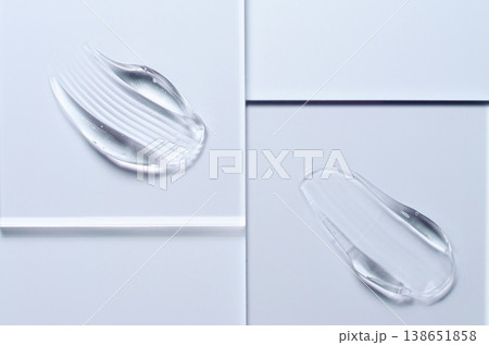 A sample of a transparent cosmetic skin care product on glass. Blue background 138651858