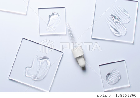 A sample of a transparent cosmetic skin care product on glass. Blue background 138651860