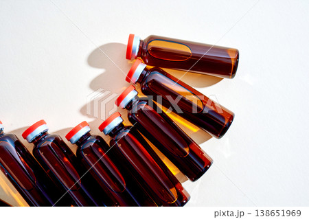 Amber glass medical vials with red caps Amber glass medical vials with red caps 138651969
