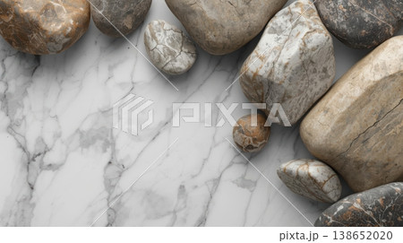 Smooth pebbles are displayed artfully on a luxurious marble surface, creating a calming and natural composition for backgrounds and designs. 138652020