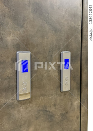 Elevator control panel on a metallic wall with illuminated digital displays, concept of technology Elevator control panel on a metallic wall with illuminated digital displays, concept of technology 138652042