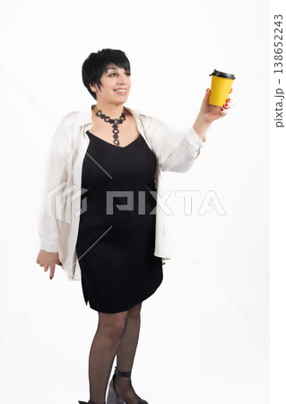 Woman holding two cups of coffee and smiling in studio Woman holding two cups of coffee and smiling in studio 138652243