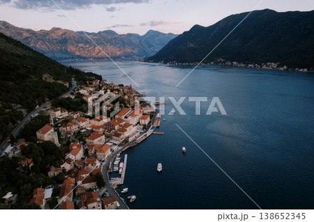 Coastal Twilight Scene. Serene Coastal Bay Reflecting Twilight Glow And Mountain Enclosure Coastal Twilight Scene. Serene Coastal Bay Reflecting Twilight Glow And Mountain Enclosure 138652345