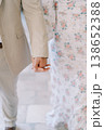 Closeup Of Hands During Stroll. Holding Hands While Walking In Floral Dress And Suit 138652388