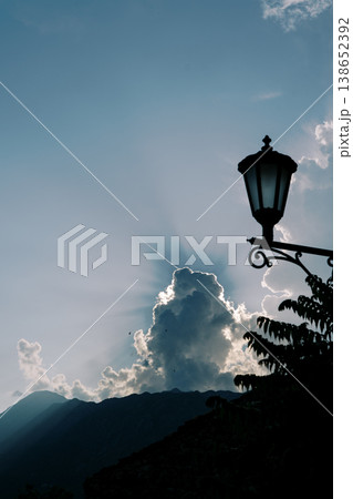 Skyward Illuminated Scene. Serene Outdoor Landscape With Majestic Mountain And Glowing Clouds Skyward Illuminated Scene. Serene Outdoor Landscape With Majestic Mountain And Glowing Clouds 138652392
