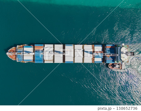 Container ship. Export and import. Cargo business. Shipping logistics. Cargo ship with container, aerial top view. Freight container on cargo vessel. Cargo ship vessel leaving port. Commercial vessel 138652736
